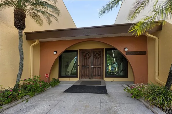 Entrance to property with stucco siding
