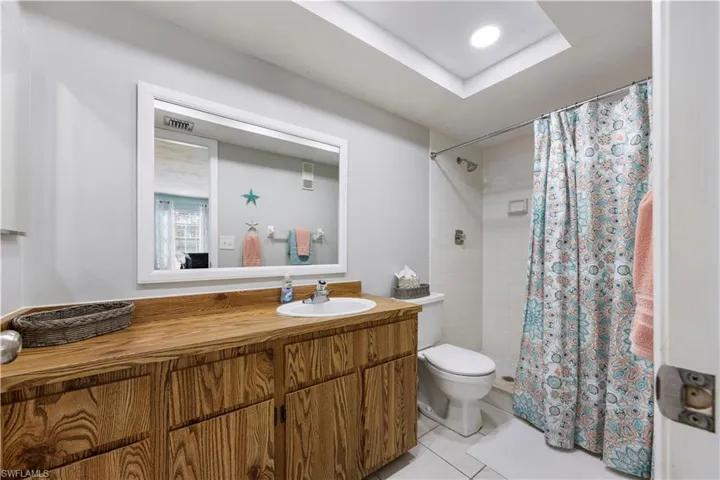 Full bathroom featuring a shower stall, vanity, light tile patterned floors, and recessed lighting