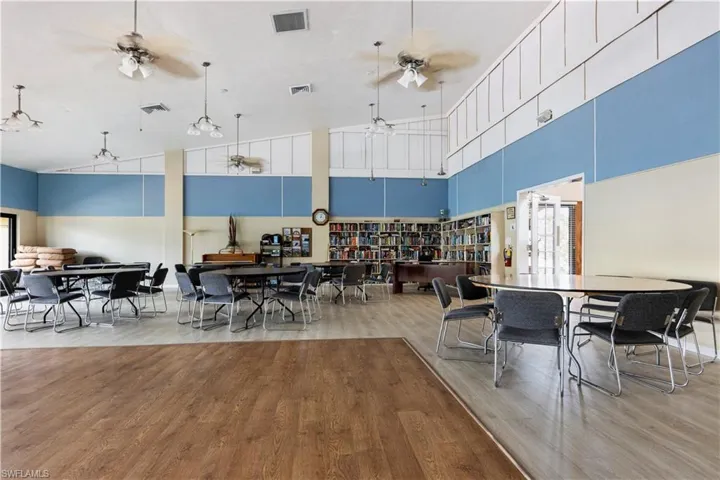 Dining area featuring light wood finished floors and vaulted ceiling