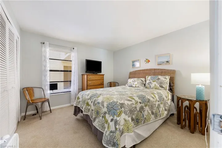 Bedroom featuring a closet and light colored carpet