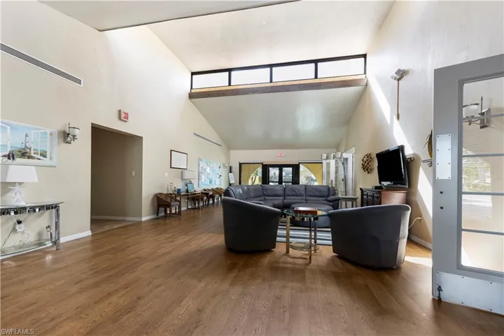 Living area with wood finished floors and lofted ceiling