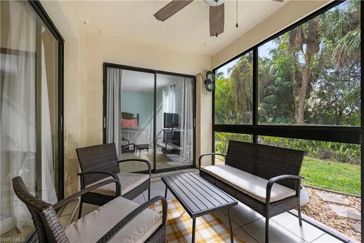 Sunroom featuring ceiling fan and an outdoor living space