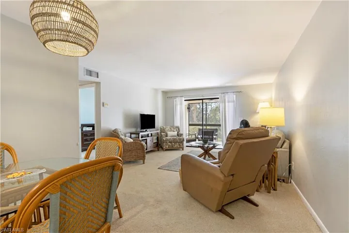 Living room featuring light colored carpet and baseboards