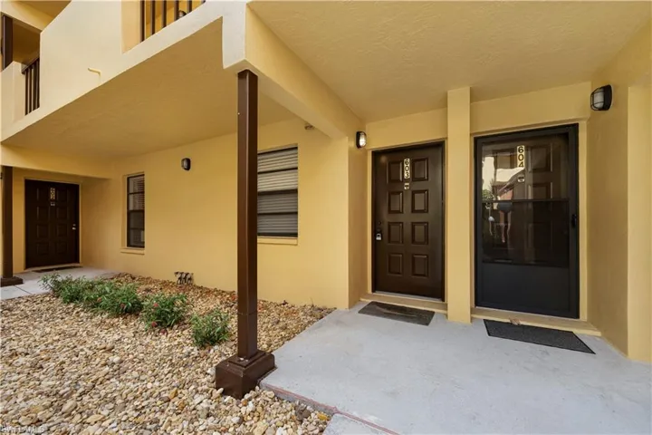 Property entrance featuring stucco siding and a porch
