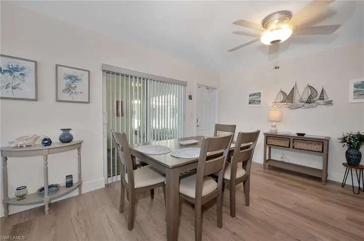 Dining room featuring light wood finished floors, a ceiling fan, and baseboards
