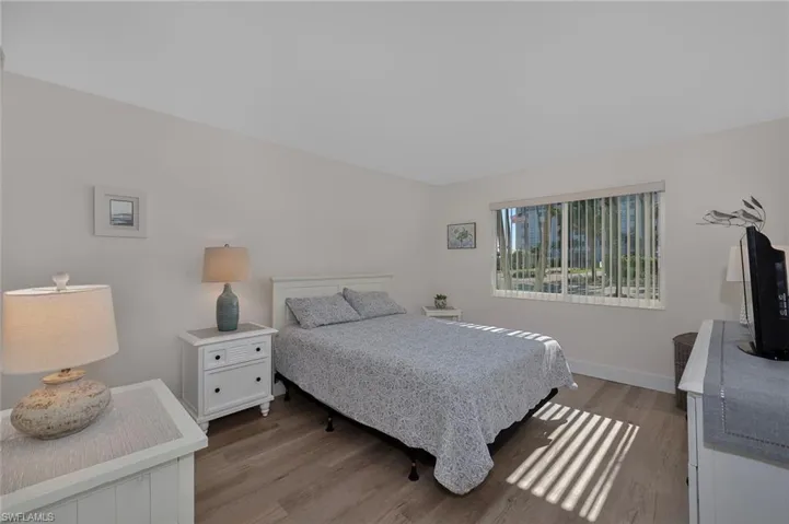 Bedroom with wood finished floors and baseboards