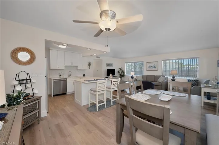 Dining area with light wood-style flooring, a wealth of natural light, recessed lighting, and ceiling fan