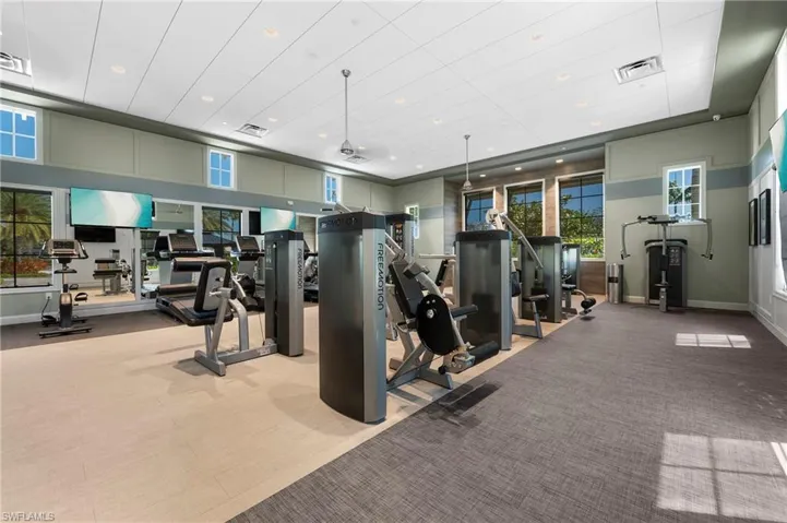 Gym with recessed lighting and a ceiling fan