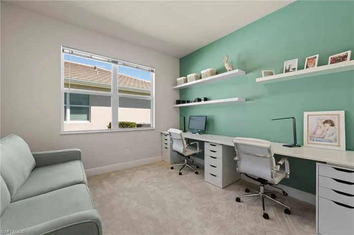 Office featuring light carpet and baseboards