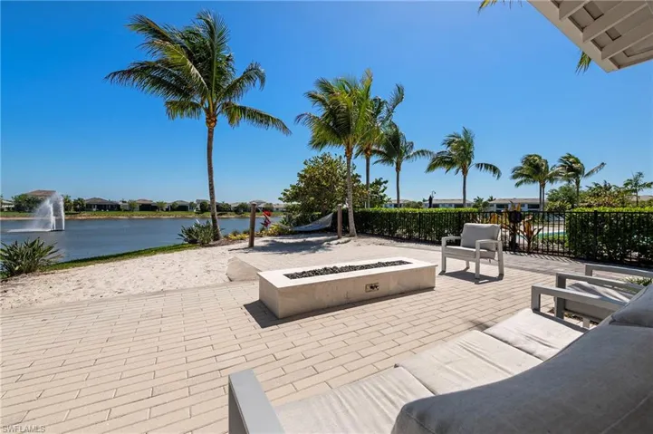 View of patio / terrace featuring a water view, an outdoor fire pit, and a residential view