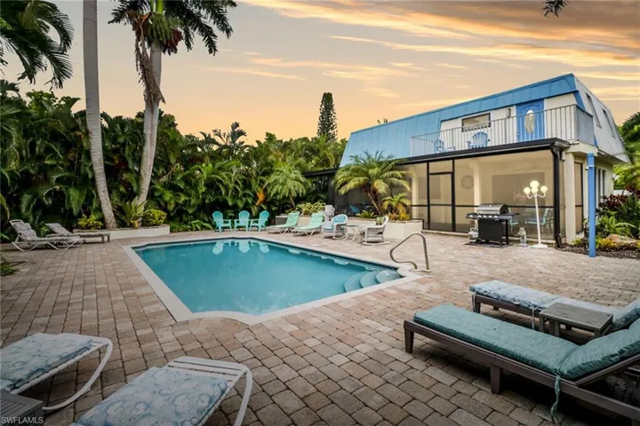 Pool at dusk with a large lanai