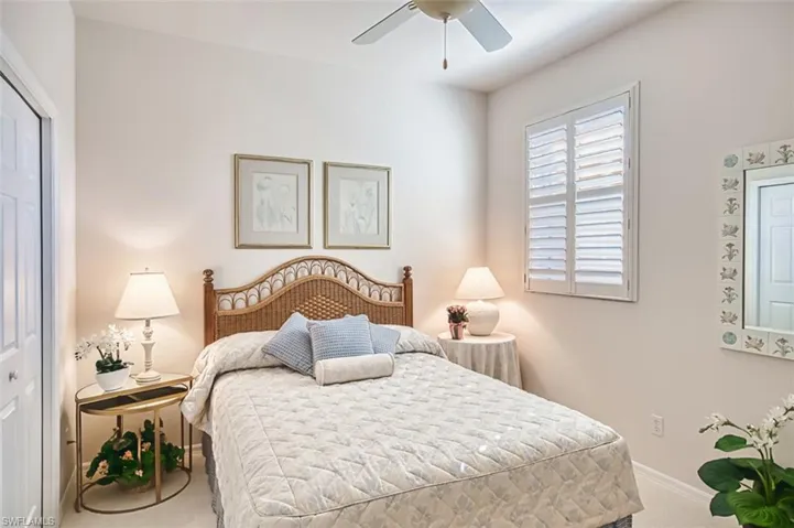 Carpeted bedroom with a closet and a ceiling fan