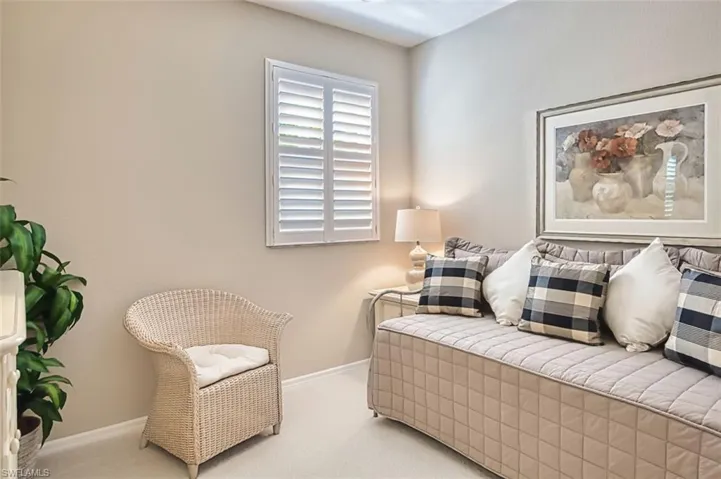 Living area with baseboards and carpet flooring