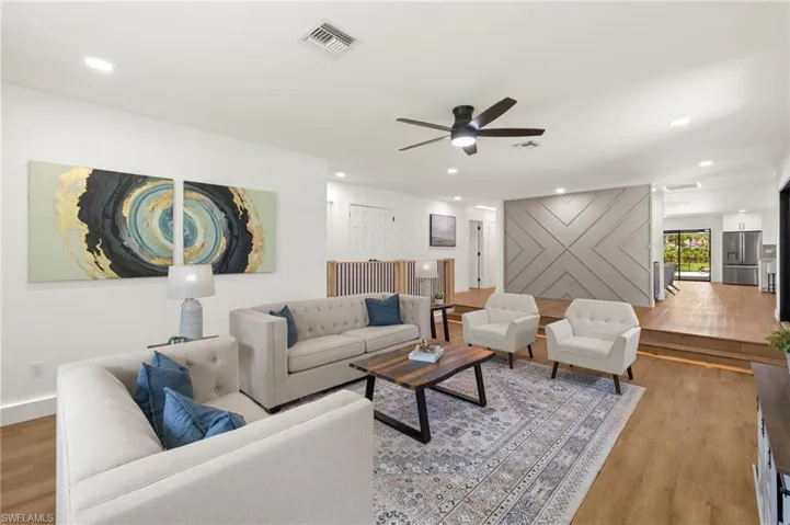 The Formal Living Room overlooks the Front Wood Feature Wall in the Foyer