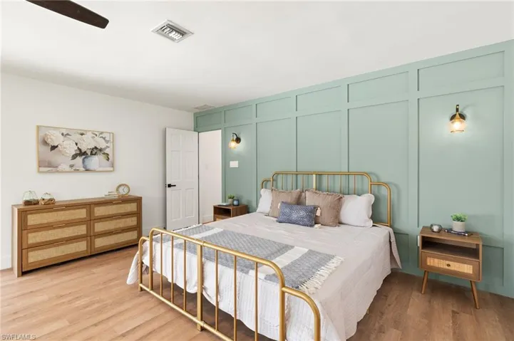 The Master Bedroom has a Custom Wood Feature Wall with Sconces