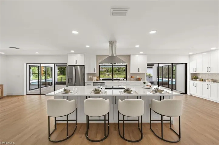 The New Kitchen features White Shaker Cabinets including Free Standing Pantries