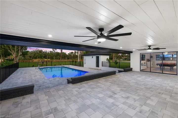 The Expansive Covered Lanai has New Brick Pavers, a Wood Plank Ceiling, New LED recess Lights, 2 Fans, etc