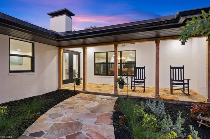 The Front Porch is so charming and has Flagstone with a Wood Plank Ceiling
