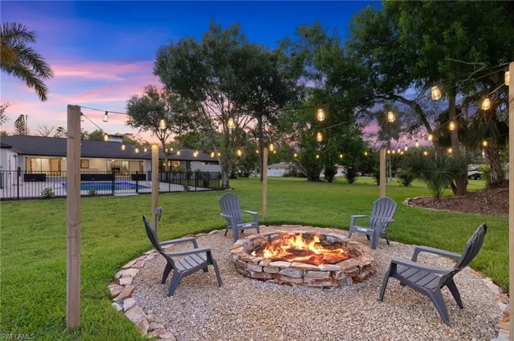 The New Firepit has Wood Posts with String Lights, Pebble Rock