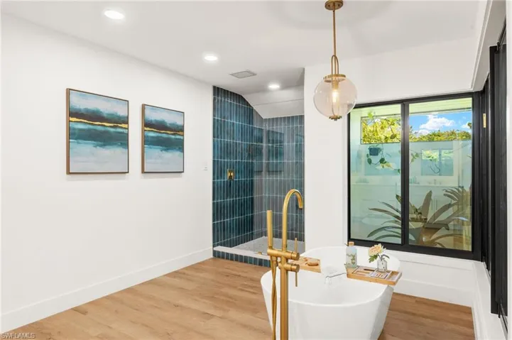 The Master Bathroom has New Subway Tiled Shower with Frameless Shower Glass
