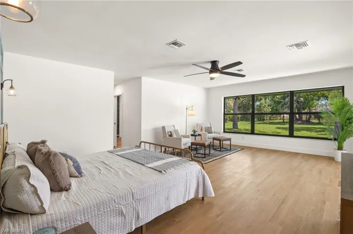The Master Bedroom has oversized Impact Glass Windows overlooking the 1.37 acres