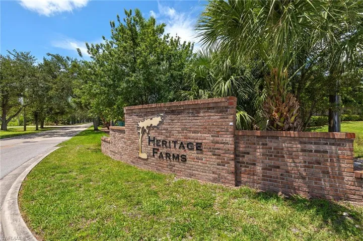 Heritage Farms Welcome Sign with Oak Tree Canopy entry road.