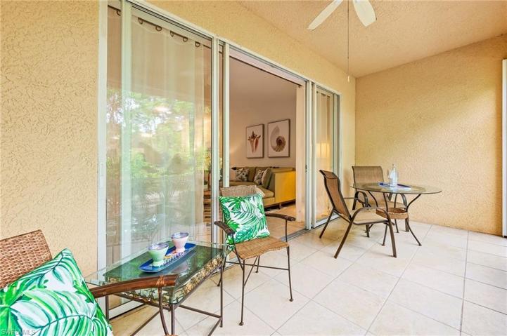 Large, private lanai facing beautiful, lush landscaping with direct access to walking trail and a lake.
