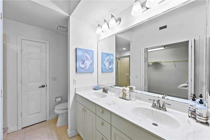 Double vanity, comfort height toilet, very roomy stand up shower.