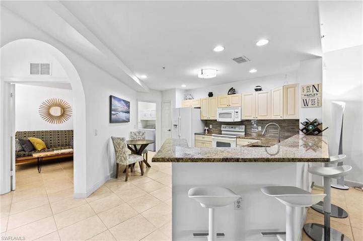 Multiple seating options for eating: breakfast bar, eat-in kitchen, and dining area nearby.