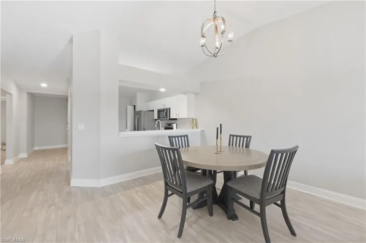 Dining room featuring light wood finished floors and hanging lights
