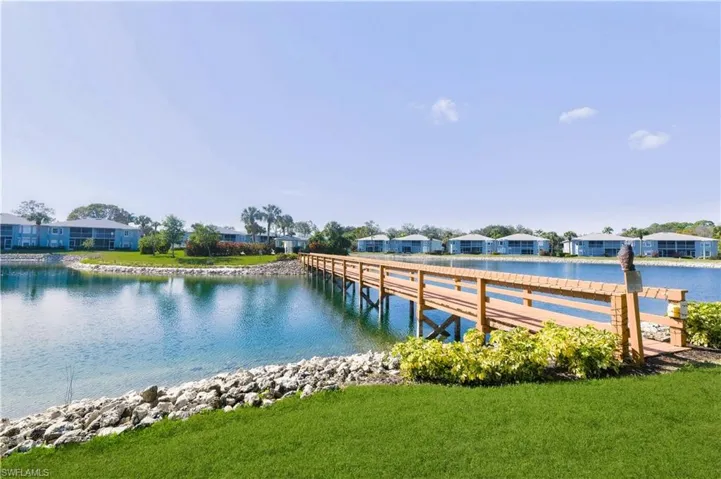Dock featuring a residential view, a water view, and a yard