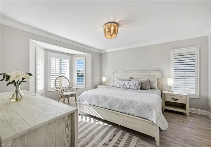 Bedroom featuring ornamental molding and light wood-style floors