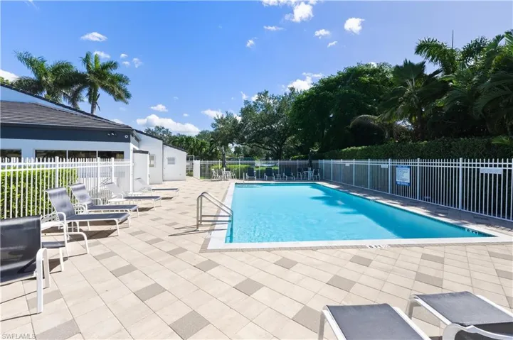 Community pool with a patio