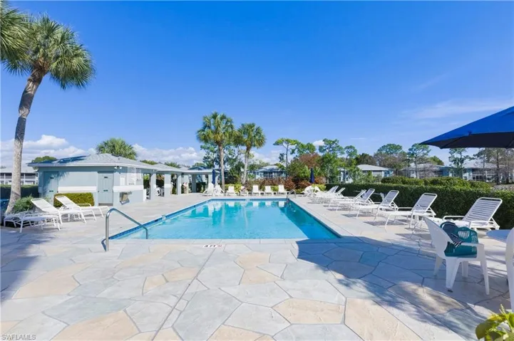 Community pool with a patio