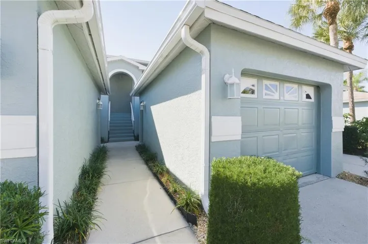 View of side of home with stucco siding and an attached garage