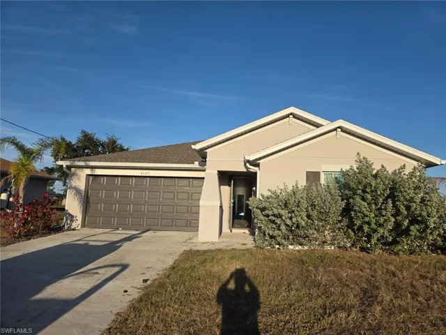 Single story home featuring stucco siding, concrete driveway, an attached garage, and roof with shingles