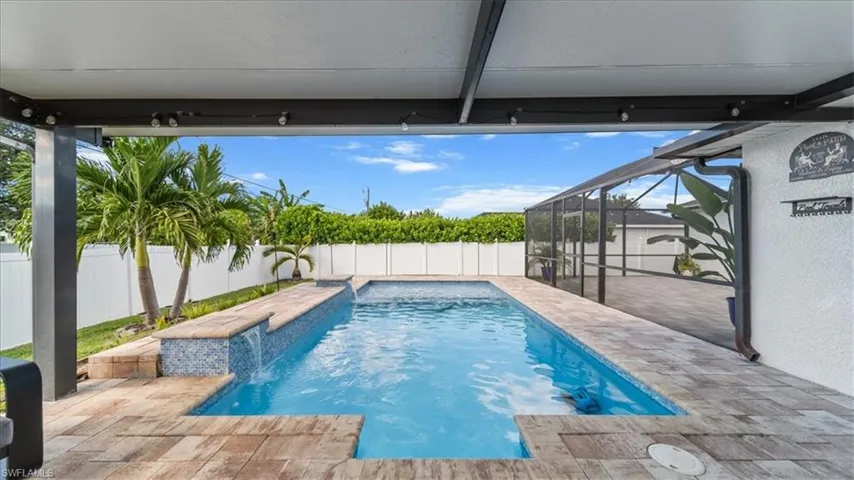 View of pool with a fenced backyard, glass enclosure, a patio, and a sunroom