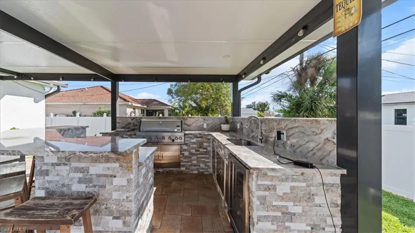 View of patio featuring an outdoor kitchen