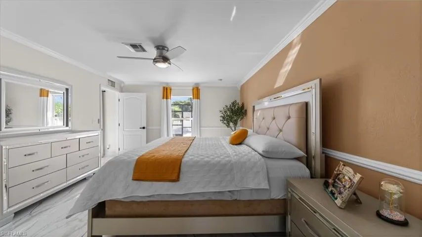 Bedroom featuring ornamental molding and a ceiling fan