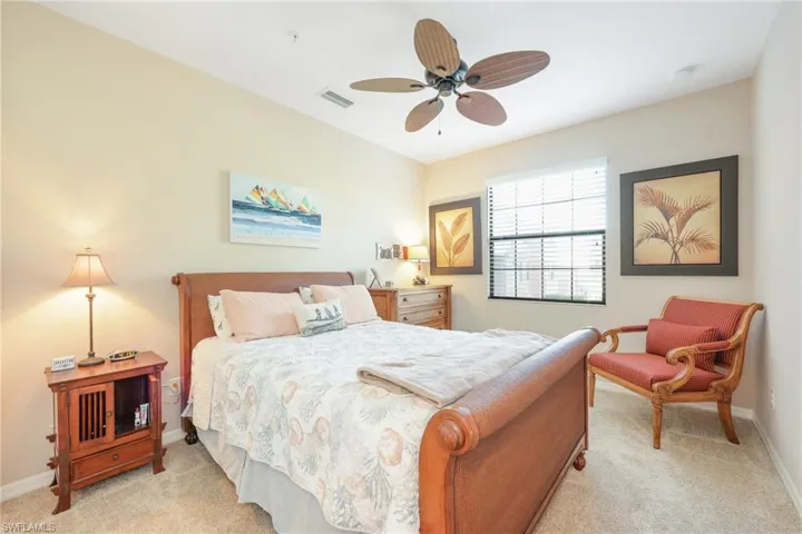 Carpeted bedroom with ceiling fan