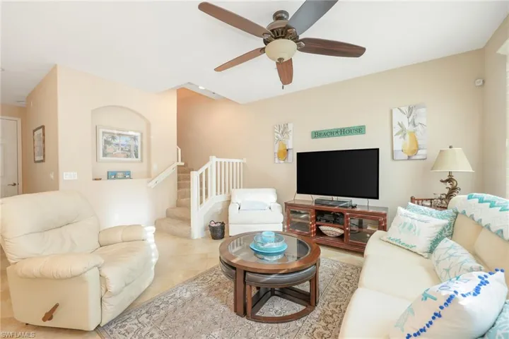 Living room featuring ceiling fan and light tile patterned floors