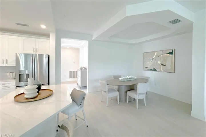 Dining area featuring baseboards and a tray ceiling