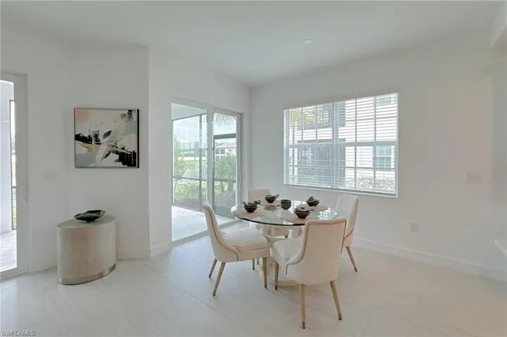 Dining space with baseboards and light tile patterned flooring