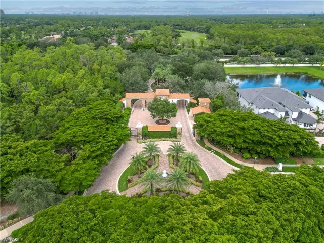 Aerial view of a nearby body of water and a heavily wooded area
