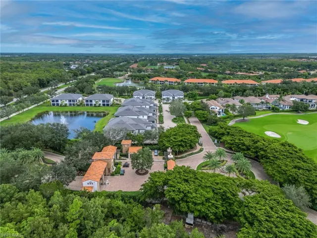 Aerial perspective of suburban area with a nearby body of water and a golf club