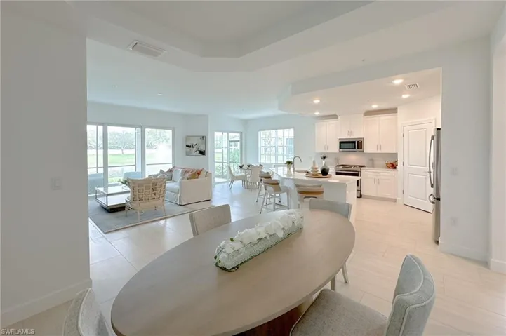 Living room with recessed lighting and a raised ceiling