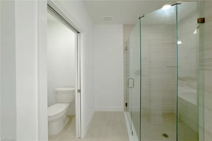 Bathroom with toilet and a stall shower