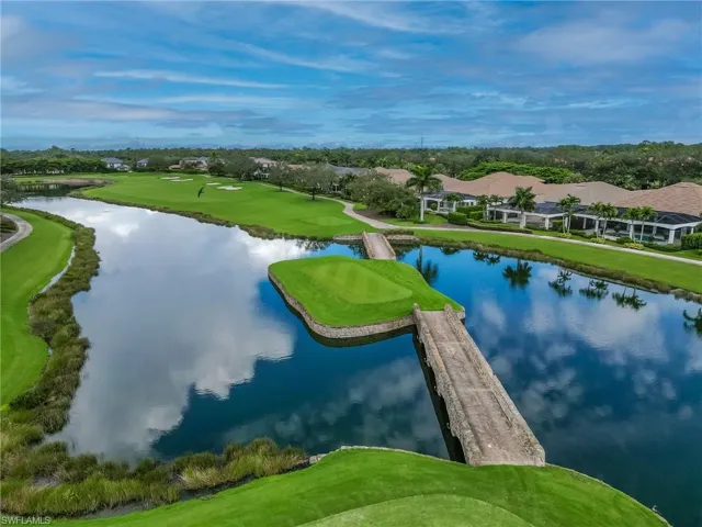 Aerial view of a golf course and a nearby body of water