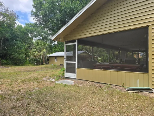 View of yard featuring a sunroom