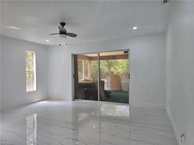 Spare room featuring recessed lighting, marble finish floor, baseboards, and a ceiling fan
